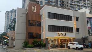 a white car parked in front of a building at SVJ Hotel in Cebu City