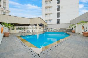 a swimming pool in front of a building at Tanea by Kozystay - Braga in Bandung