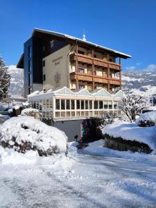 a large building in the snow with snow covered premises at Dolomitenhotel Lienz in Lienz