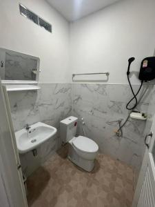 a white bathroom with a toilet and a sink at ไสวรีสอร์ท Sawai Resort in Ban Khao Noi