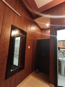 a bathroom with a mirror and a sink at Hotel Jalsa in Haridwār