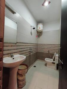 a bathroom with a sink and a toilet at Hotel Jalsa in Haridwār +63 photos