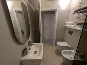 a bathroom with a sink and a toilet and a mirror at Fp Monza Railways in Monza +9 photos