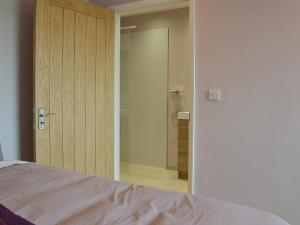 a bedroom with a sliding glass door with a shower at Aimmee's Lodge - Ukc2203 in Doddington