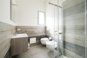 a bathroom with a toilet and a sink and a shower at B&B a due passi dal centro in Castelsardo +42 photos