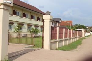 a fence in front of a house at Avalon Apartment 2 in Vientiane