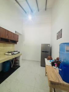 a kitchen with a counter and a refrigerator at HotelSide Residences in Negombo