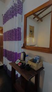 a table in a room with a mirror and a sink at Sigiri Liya Rest in Sigiriya