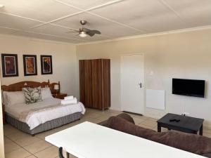 a bedroom with a bed and a flat screen tv at Eagles Overnight in Queenstown