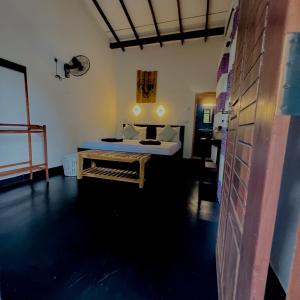 a bedroom with a bed and a table in a room at Sigiri Liya Rest in Sigiriya +65 photos