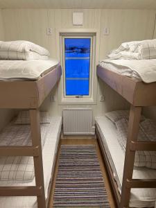 two bunk beds in a small room with a window at Hjortgården in Mora