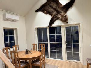 a bear hanging on the wall of a dining room at Hjortgården in Mora +4 photos