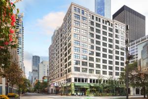 a tall white building in the middle of a city at Hampton Inn & Suites Chicago-Downtown in Chicago