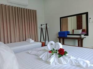 a hotel room with two beds with white sheets at Niramit Pool Villa in Ban Chong Phli +19 photos