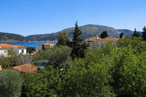 a view of a town with a lake and mountains at Agali Beach Apartments Seaside Stay in Chios in Mármaron