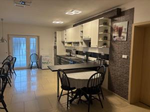 a kitchen with a table and chairs in a room at Ubytování U draka in Třeboň