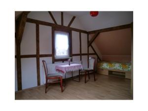 a room with a table and two chairs and a window at Ferienhaus Krabiell in Saalfeld