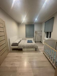 a room with a bed and a staircase in it at AV Apartment in Rēzekne
