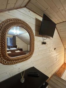 a mirror on the wall of a tiny house at Лісова тиша Дворівневий Люкс in Synevyrsʼka Polyana