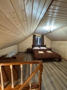 a bedroom with two beds in a attic at Лісова тиша Дворівневий Люкс in Synevyrsʼka Polyana
