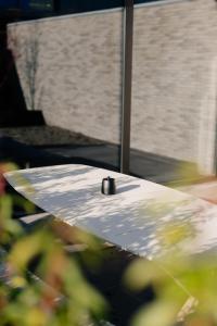 a table with a metal object on top of it at Coliving - Bord de Meuse - L'écrin Vert in Oupeye