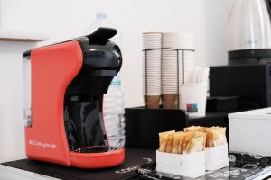 a red mixer sitting on a counter with food at B&B a due passi dal centro in Castelsardo