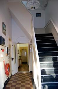 a hallway of a building with a staircase at Pension Delfzijl in Delfzijl