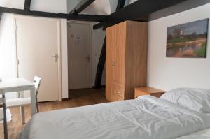 a bedroom with a bed and a desk at City Hostel Vlissingen in Vlissingen