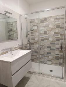 a bathroom with a sink and a glass shower at AmarMare Bed&Breakfast in Trappeto +79 photos