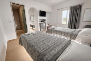 a hotel room with two beds and a kitchen at Babis Hotel in Karterados