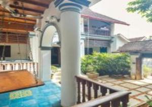 a house with a gazebo on a patio at The Mundanad House in Trivandrum