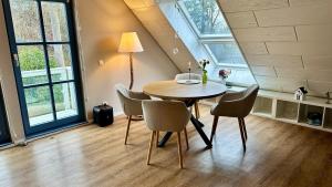 a dining room with a table and chairs at Fewo Ostseetraum Laboe in Laboe +13 photos