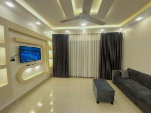 a living room with a couch and a tv at الاقصر in Luxor
