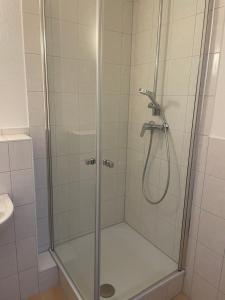 a shower stall with a glass door in a bathroom at Die Kantine Wittenburg Zimmervermietung und Hostel in Wittenburg