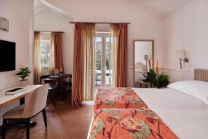 a hotel room with a bed and a desk and a table at Amadria Park Apartments Šibenik in Šibenik +99 photos