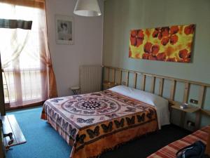 A bed or beds in a room at Le Magnolie B&B