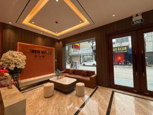 a lobby of a store with a couch and a table at Khách sạn XMen Thanh Hóa - Không gần biển in Thanh Hóa