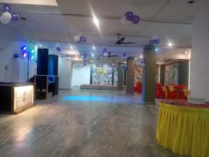 a large room with purple balloons and a table at Hotel Taj Signature in Tājganj