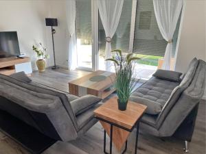 a living room with a couch and a table at Sorinas Home - Comfortable Apartment near Graz - Free Parking in Wagersbach