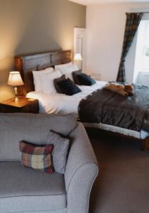 a bedroom with a large bed and a couch at The Newport Inn in Newport-On-Tay +4 photos