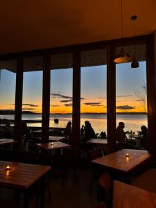 a restaurant with tables and a view of the water at The Newport Inn in Newport-On-Tay