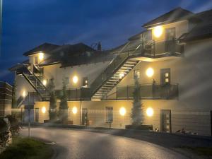 a building with a staircase on the side of it at night at Sorinas Home - Comfortable Apartment near Graz - Free Parking in Wagersbach
