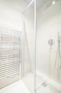 a shower with a glass door in a bathroom at Dreamyflat - Apartment Opera 3 in Paris