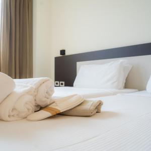 a hotel room with a pair of shoes on a bed at Hotel Capannelle Roma in Rome
