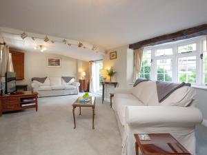 a living room with a white couch and a table at Little Millhayes in Thorverton