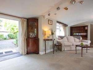 a living room with a couch and a window at Little Millhayes in Thorverton