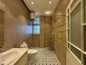 a bathroom with a toilet and a sink and a shower at Pineridge Hotel at Mall Road in Darjeeling