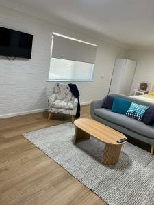 a living room with a couch and a coffee table at Beach House Studio in Busselton