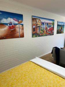 a room with three paintings on the wall at Beach House Studio in Busselton
