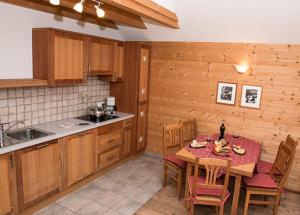 a kitchen with a table and chairs in a kitchen at Lechnerhof in Braies